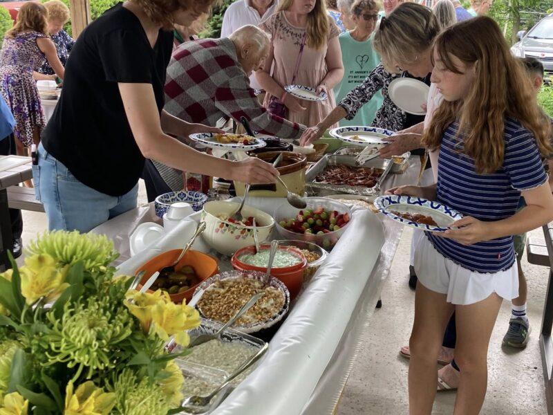 Enjoying delicious food  and Fellowship at our Church Picnic